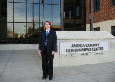 Timothy Theisen in front of the Anoka County Government Center